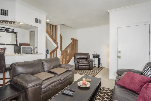 a living room with furniture and a rug