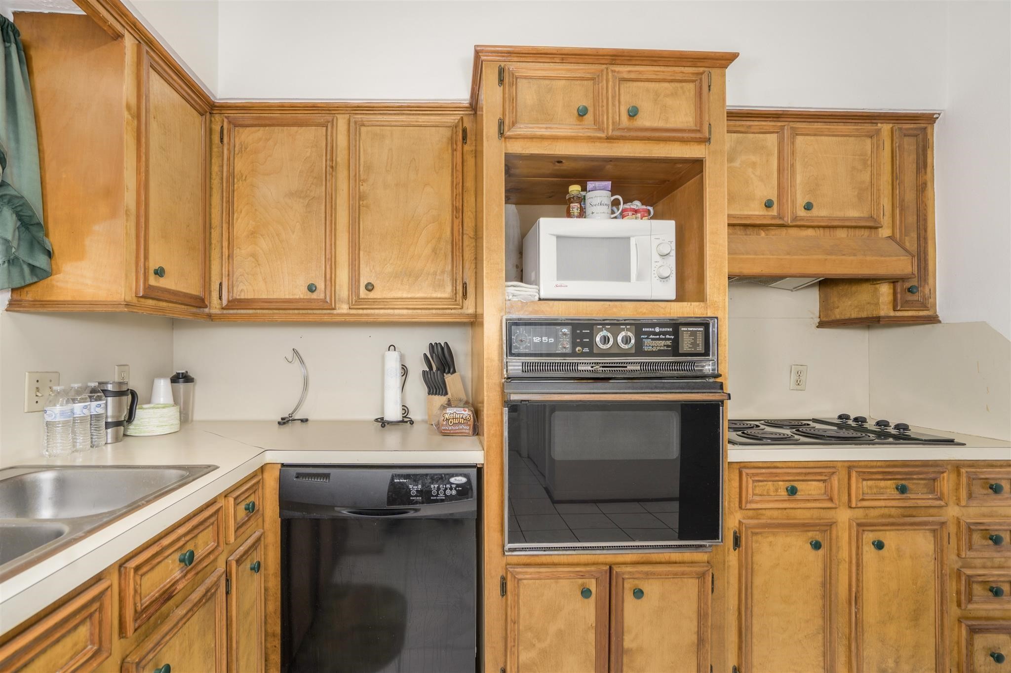 10763 Sandpiper Drive Houston, TX 77096 - Photo 5 of 26 a kitchen with stainless steel appliances granite countertop a stove and a sink