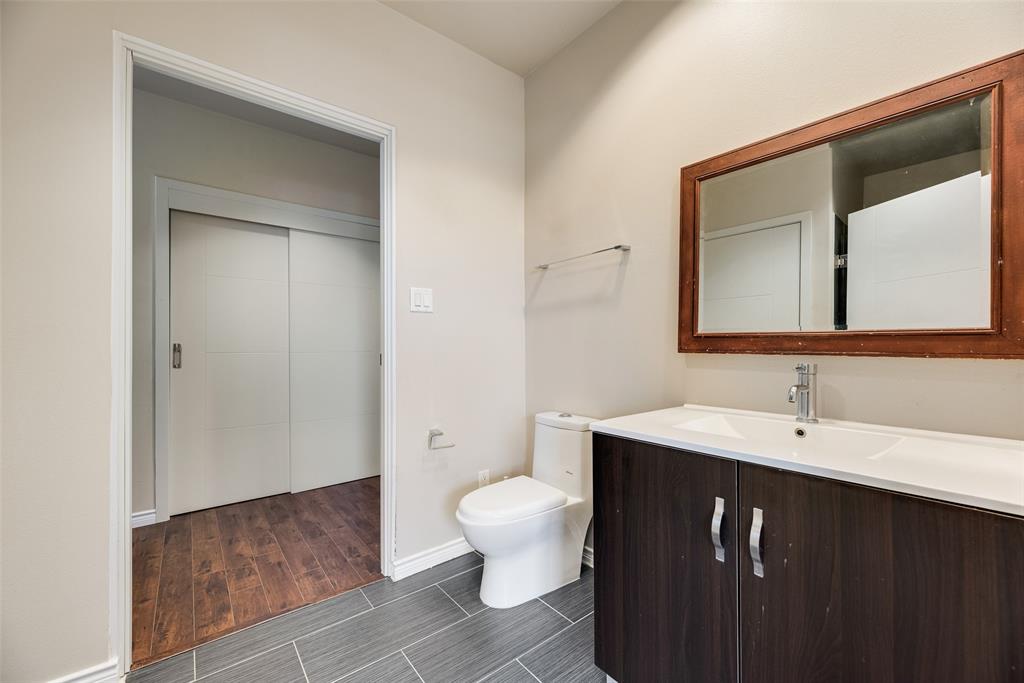 1100 West Trinity Mills Road, Unit 2040 Carrollton, TX 75006 - Photo 17 of 21 a bathroom with a toilet sink and mirror