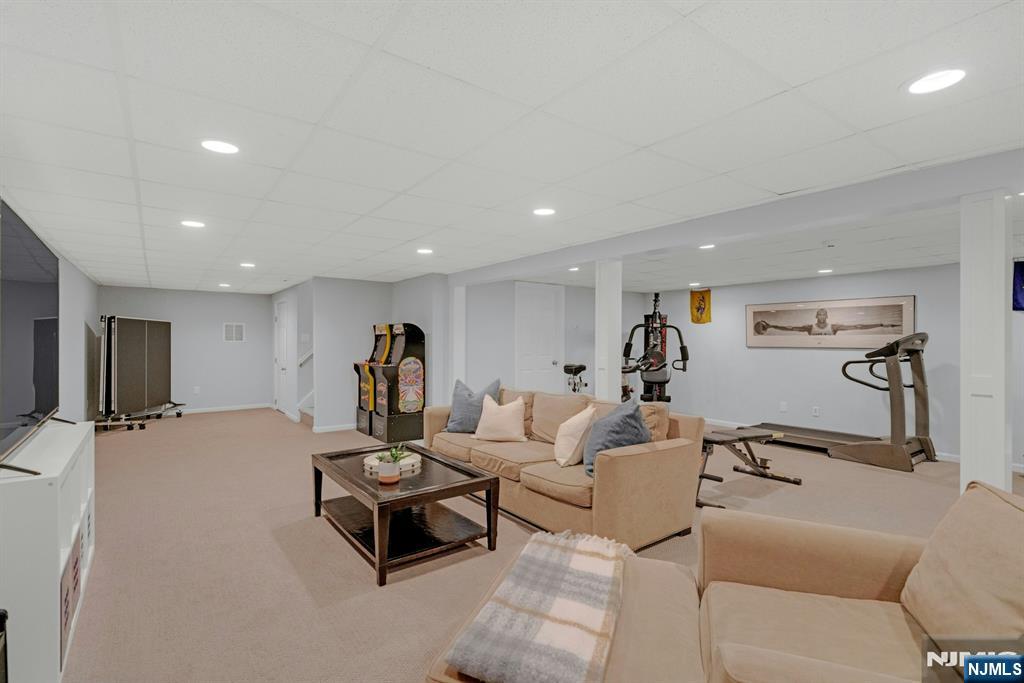 48 Hopper Farm Road Upper Saddle River, NJ 07458 - Photo 36 of 43 a living room with furniture and a gym equipment
