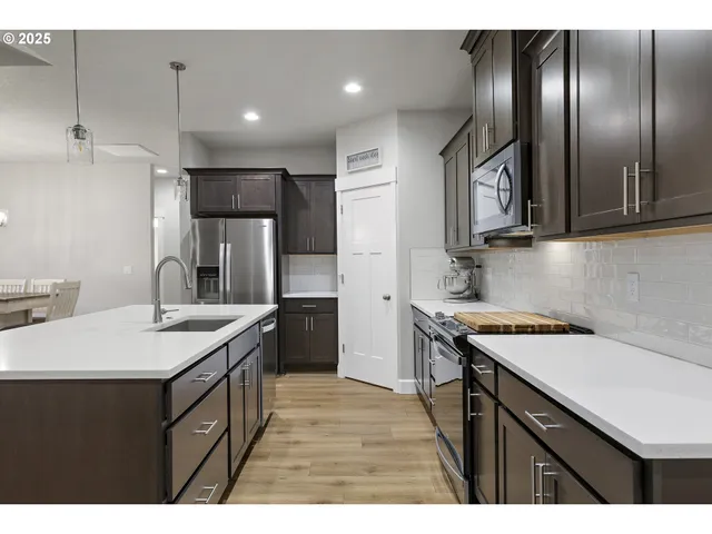 a kitchen that has a sink and a stove in it