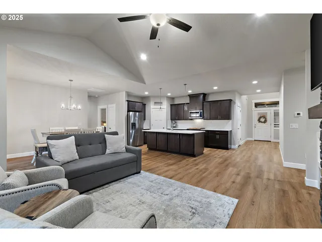 a living room with furniture and kitchen view