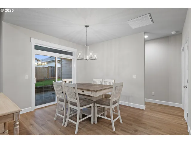 a view of a dining room with furniture wooden floor and chandelier