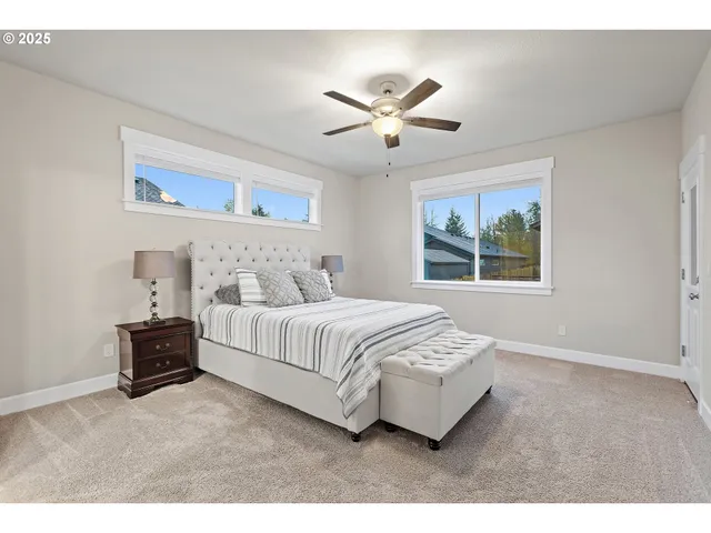 a bedroom with a large bed and a chandelier