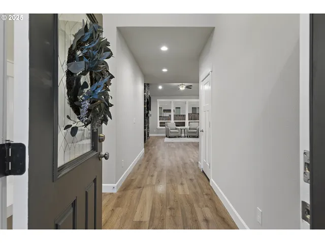a view of a hallway with wooden floor