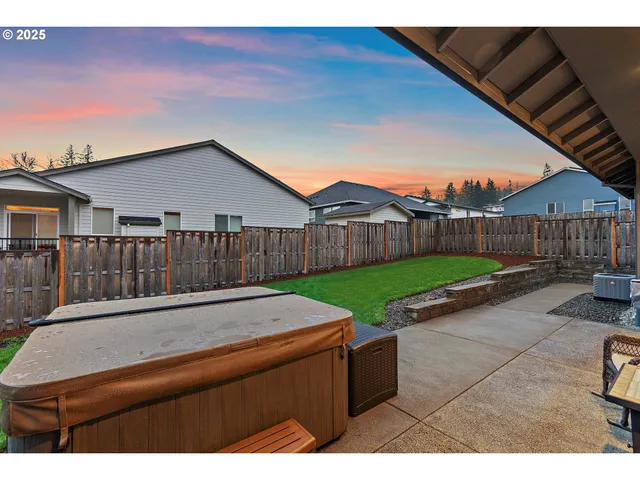 a view of a terrace with chairs and a yard