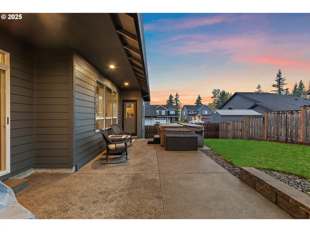 a living room with furniture a window and stainless steel appliances