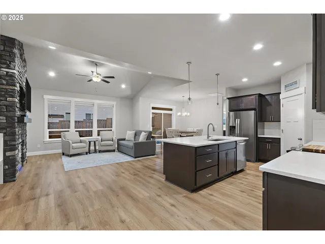 a living room with stainless steel appliances kitchen island granite countertop lots of counter top space