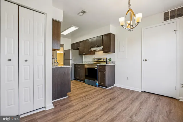 a kitchen with stainless steel appliances a refrigerator and a stove top oven