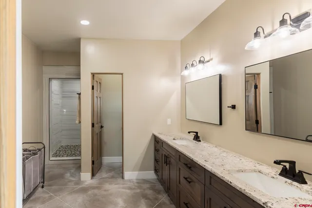 a bathroom with a double vanity sink mirror and double