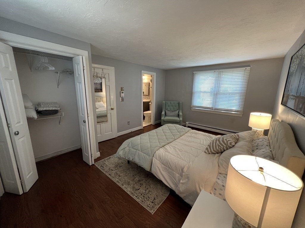 12 State Road, Unit 2E Plymouth, MA 02360 - Photo 10 of 28 a spacious bedroom with a bed and a mirror