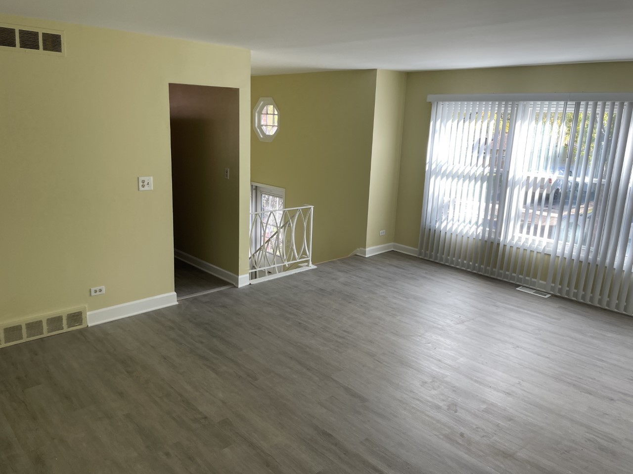 6830 Valley View Road Hanover Park, IL 60133 - Photo 4 of 14 an empty room with wooden floor and windows