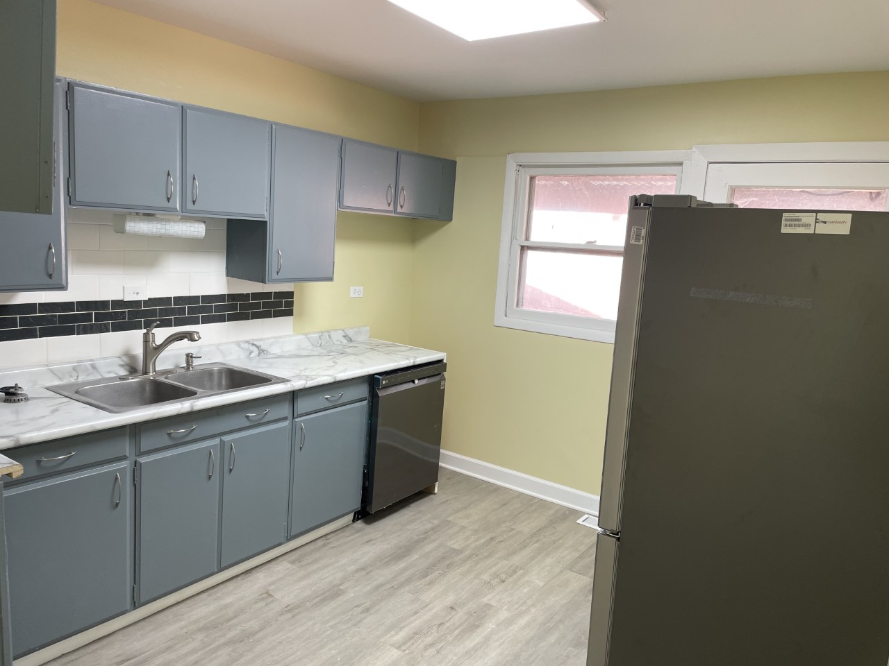 6830 Valley View Road Hanover Park, IL 60133 - Photo 5 of 14 a kitchen with stainless steel appliances granite countertop a sink and dishwasher with wooden cabinets