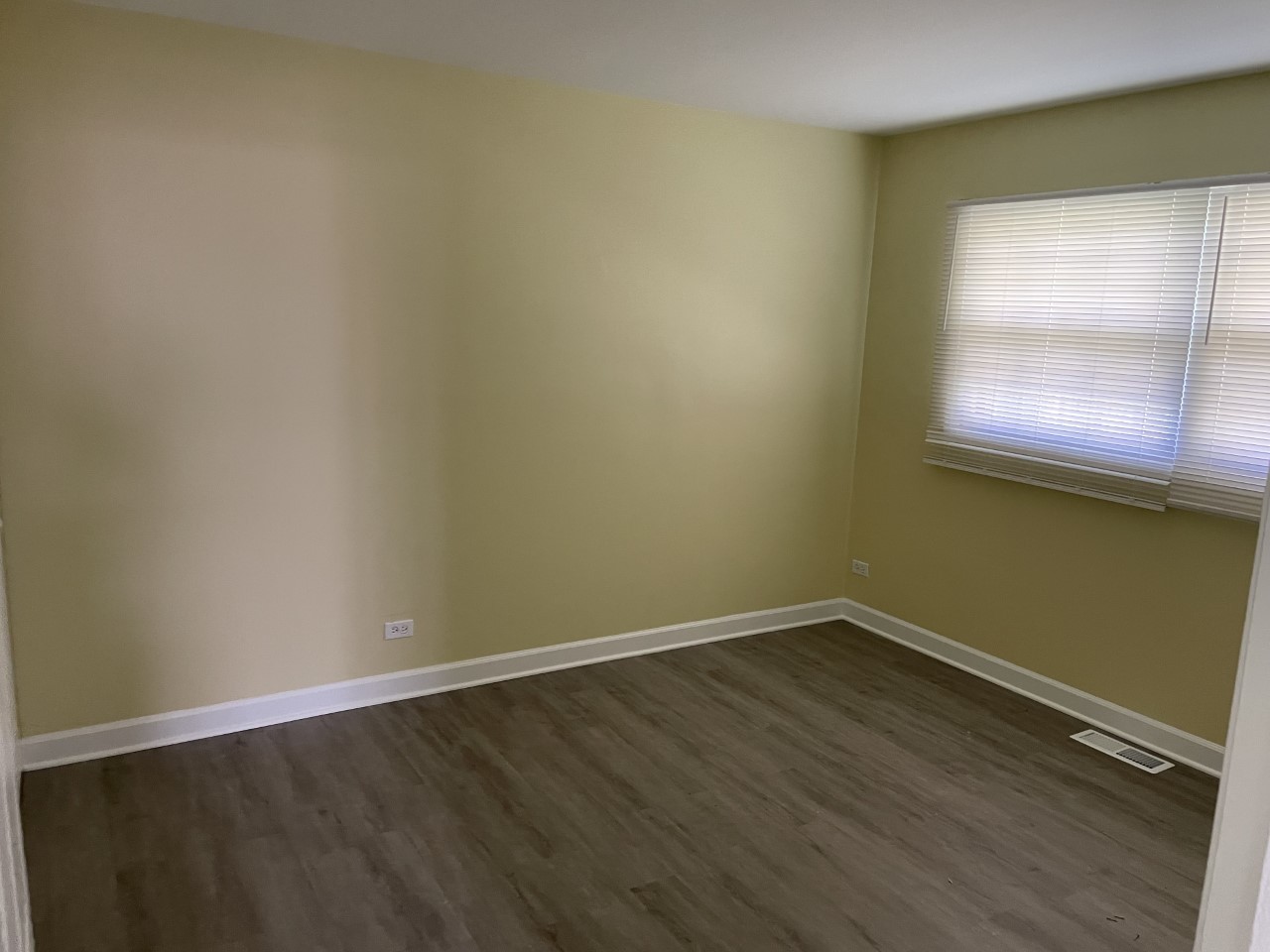 6830 Valley View Road Hanover Park, IL 60133 - Photo 7 of 14 an empty room with wooden floor and windows