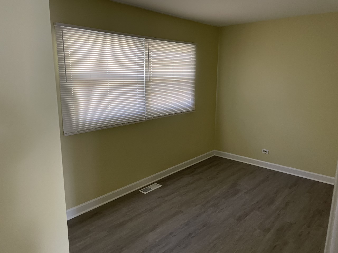 6830 Valley View Road Hanover Park, IL 60133 - Photo 8 of 14 an empty room with wooden floor and windows