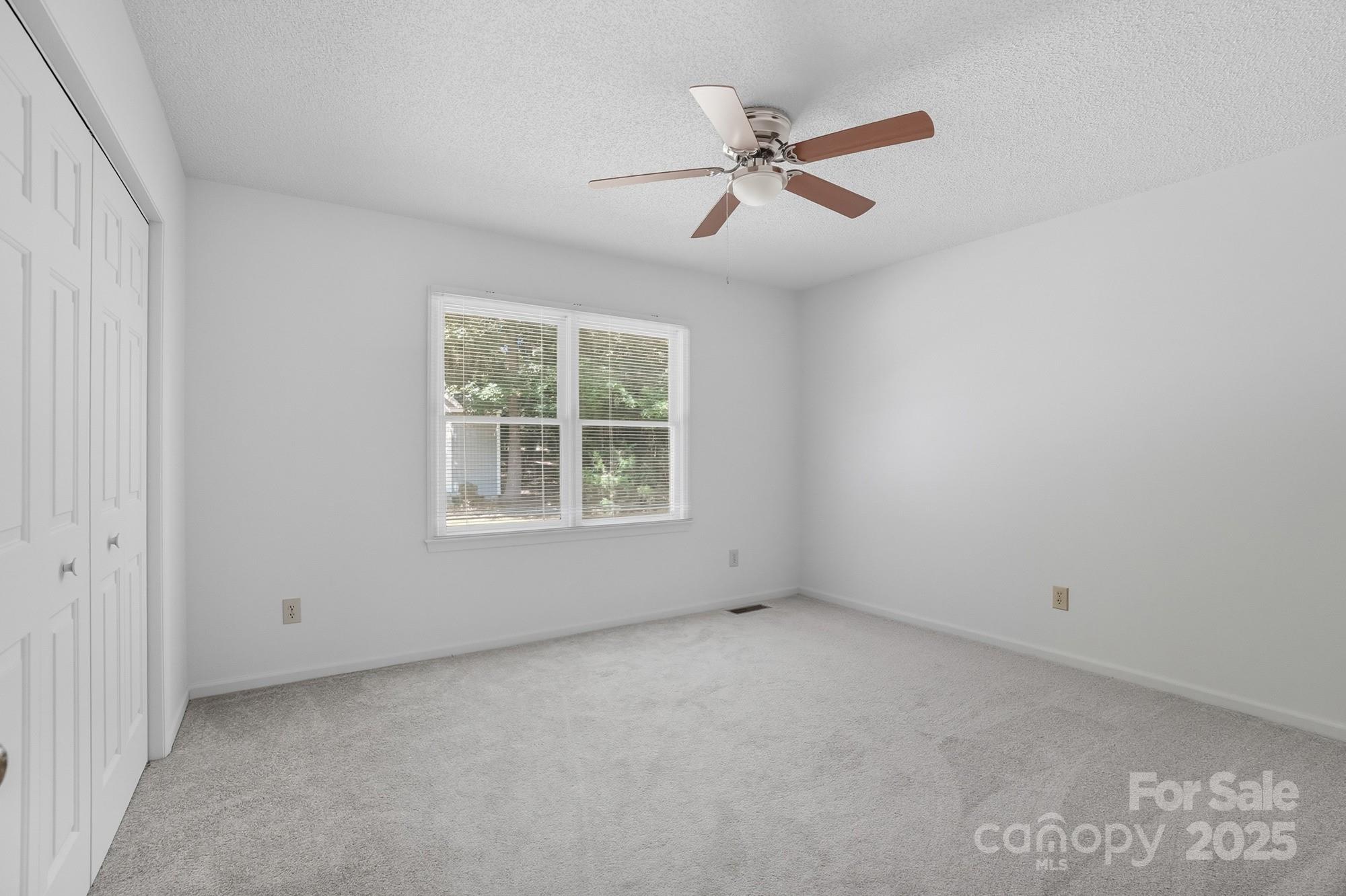 803 Victorian Lane Monroe, NC 28112 - Photo 13 of 46 an empty room with windows and fan