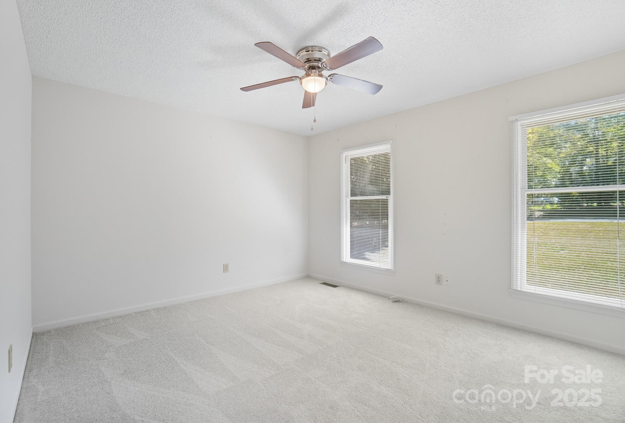 803 Victorian Lane Monroe, NC 28112 - Photo 18 of 46 an empty room with window and ceiling fan