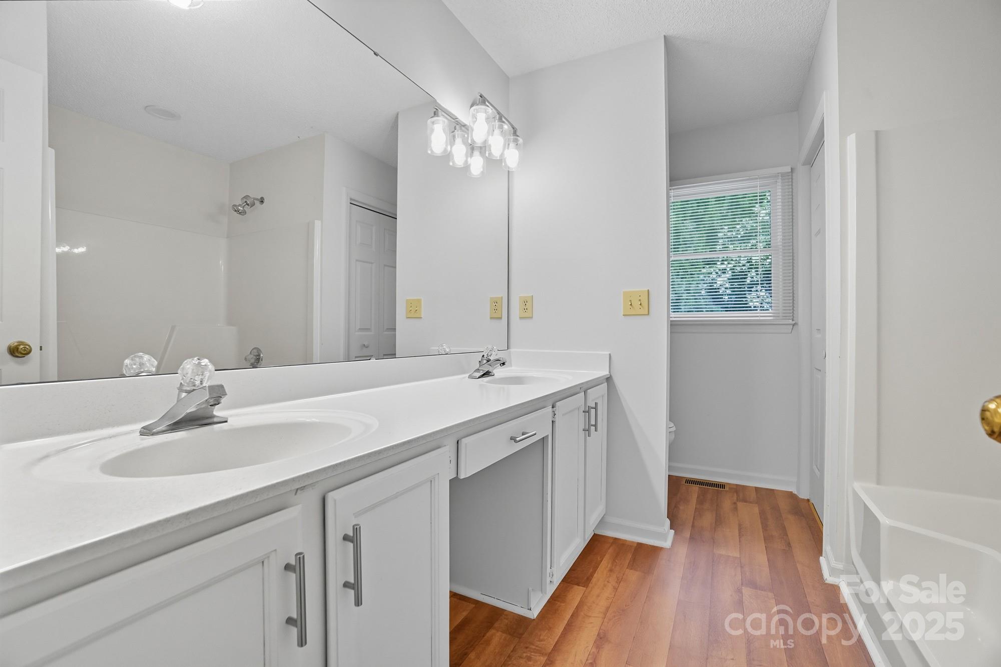 803 Victorian Lane Monroe, NC 28112 - Photo 27 of 46 a bathroom with a sink double vanity granite tub and shower
