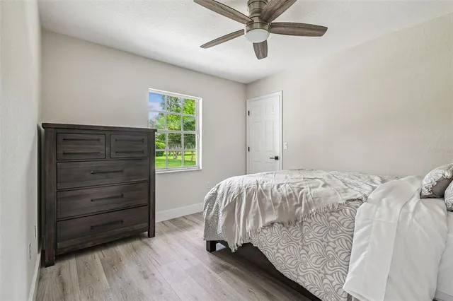 a bed sitting in a bedroom next to a window