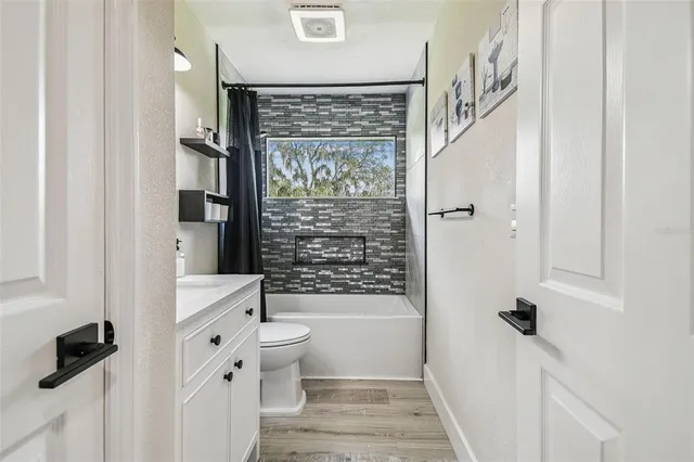 a bathroom with a toilet a sink and a shower