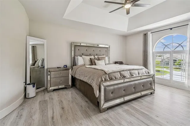 a living room with a bed furniture and a large window