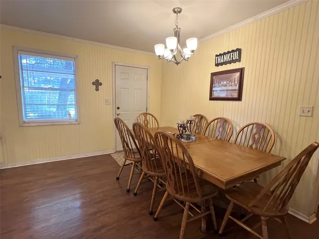 a view of a dining room with furniture wooden floor and a chandelier