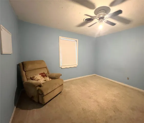 a blue bed sitting in a bedroom next to a window