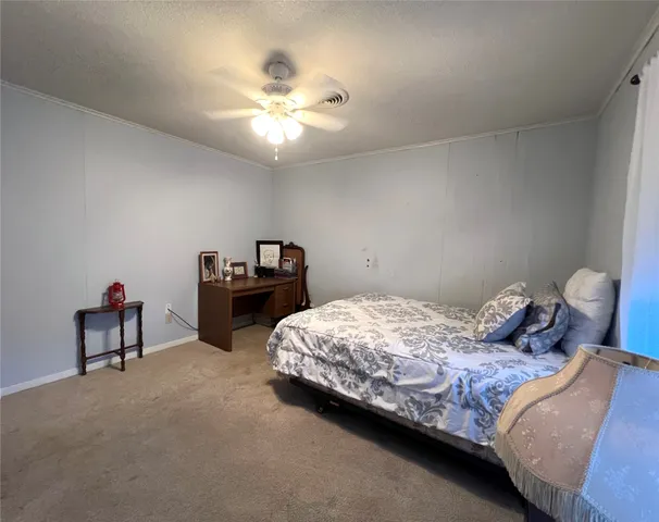 a bedroom with bed and a chandelier
