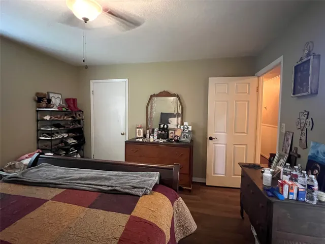 a bedroom with furniture and a wooden floor