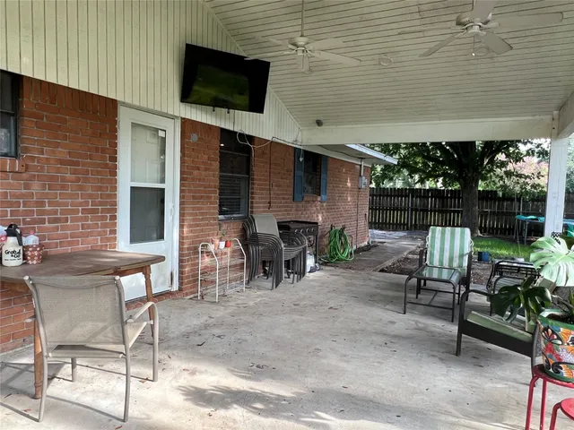 a view of a chairs and table in the back yard of the house