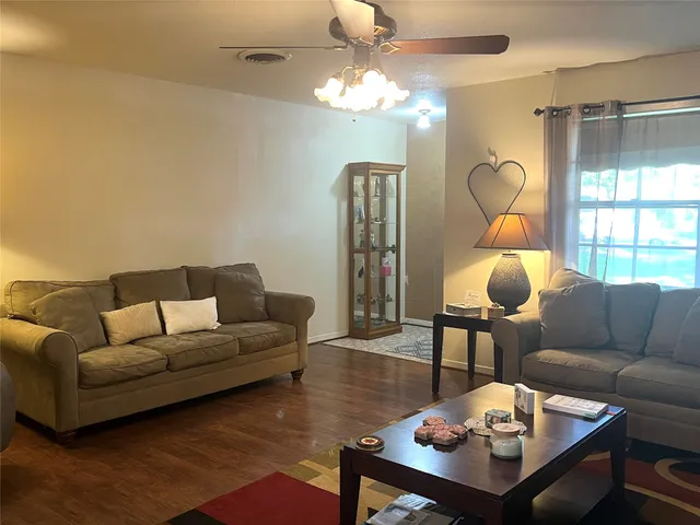 a living room with furniture a lamp and a chandelier