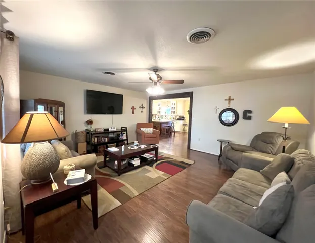 a living room with furniture and a lamp