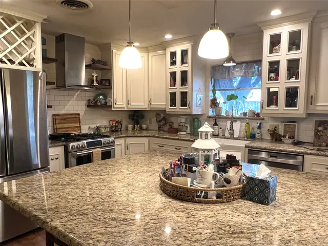 a kitchen with a stove and a refrigerator