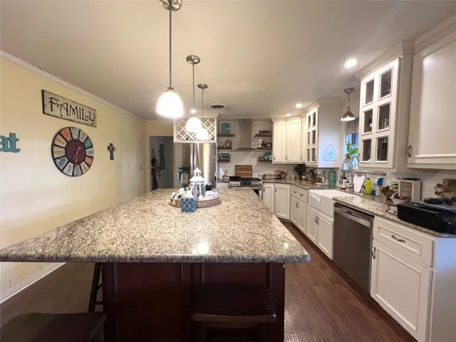 a kitchen with a kitchen island a stove and a wooden floors