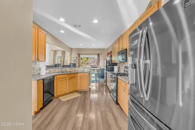 a view of a dining room with furniture large window and wooden floor