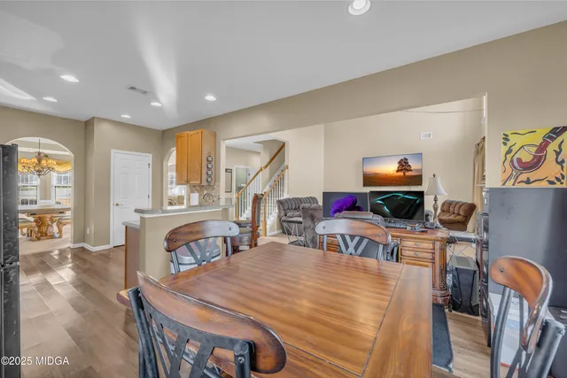 a living room with furniture a fireplace and a large window