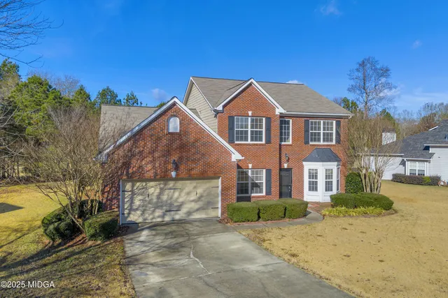 a view of a dining room with furniture and a chandelier