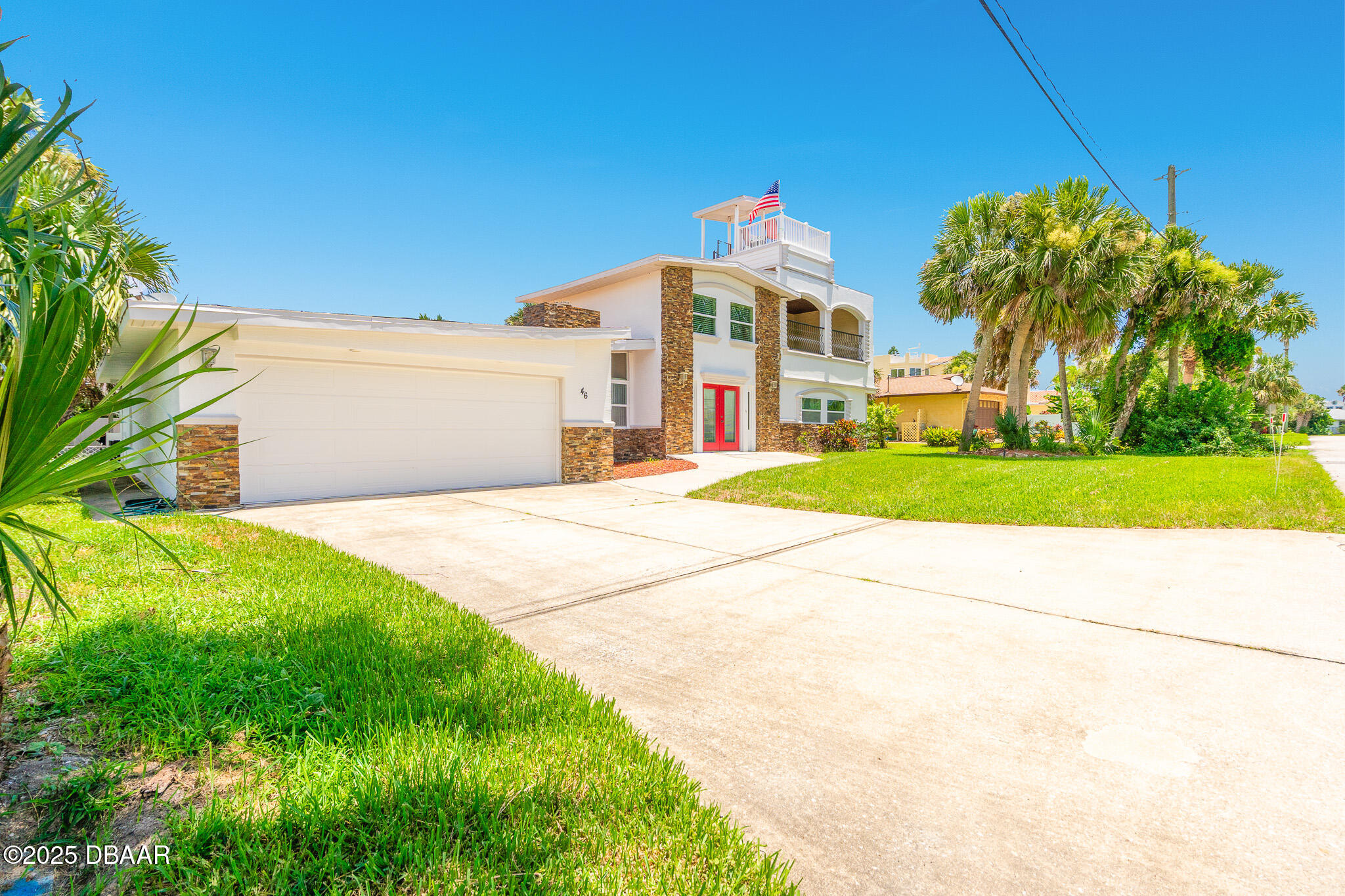 46 Oceanview Avenue Ponce Inlet, FL 32127 - Photo 67 of 79 a front view of a house with a yard and garage