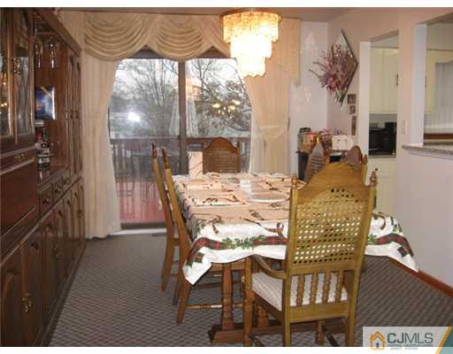 9 Birch Road Edison, NJ 08817 - Photo 4 of 10 a view of a dining room with furniture a chandelier and wooden floor