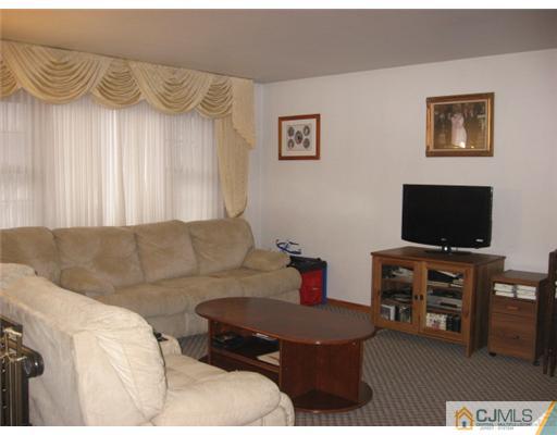 9 Birch Road Edison, NJ 08817 - Photo 5 of 10 a living room with furniture and a flat screen tv
