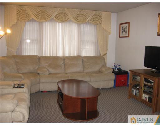 9 Birch Road Edison, NJ 08817 - Photo 6 of 10 a living room with furniture and a flat screen tv