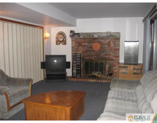 9 Birch Road Edison, NJ 08817 - Photo 9 of 10 a view of living room kitchen with furniture and fireplace