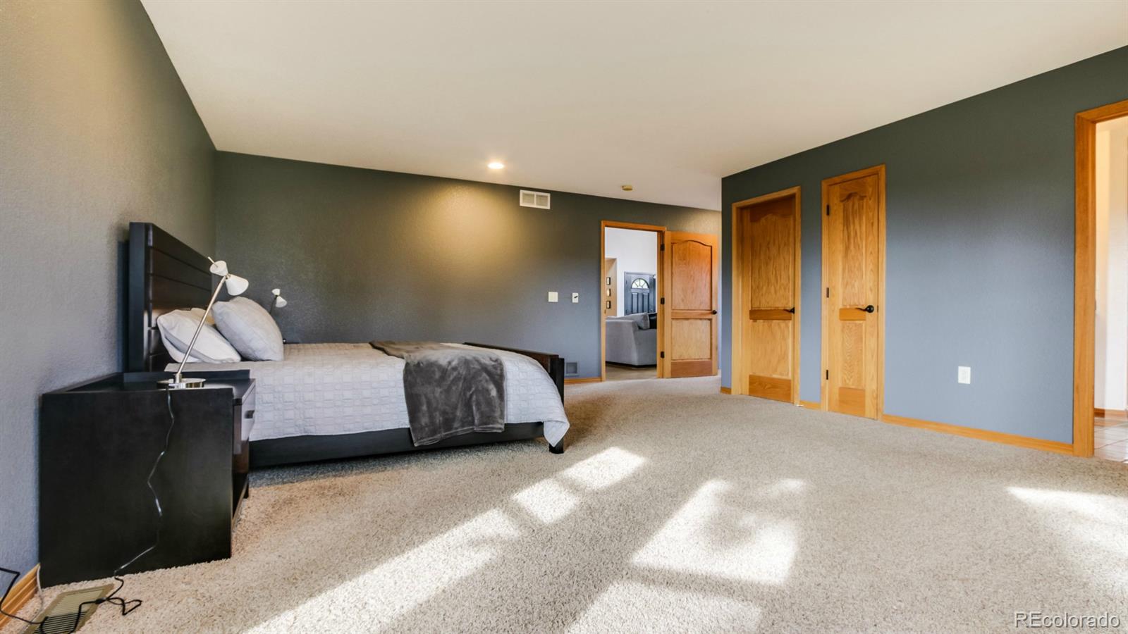 50 South Pine Road Golden, CO 80401 - Photo 17 of 35 a bedroom with a bed and wooden floor