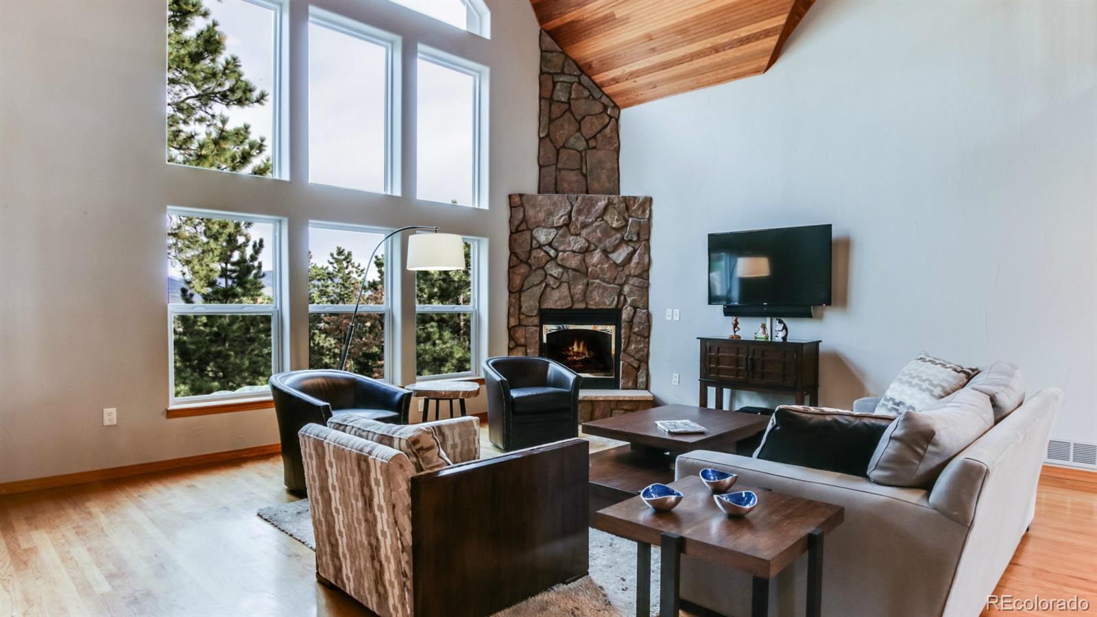 50 South Pine Road Golden, CO 80401 - Photo 2 of 35 a living room with fireplace furniture and a flat screen tv