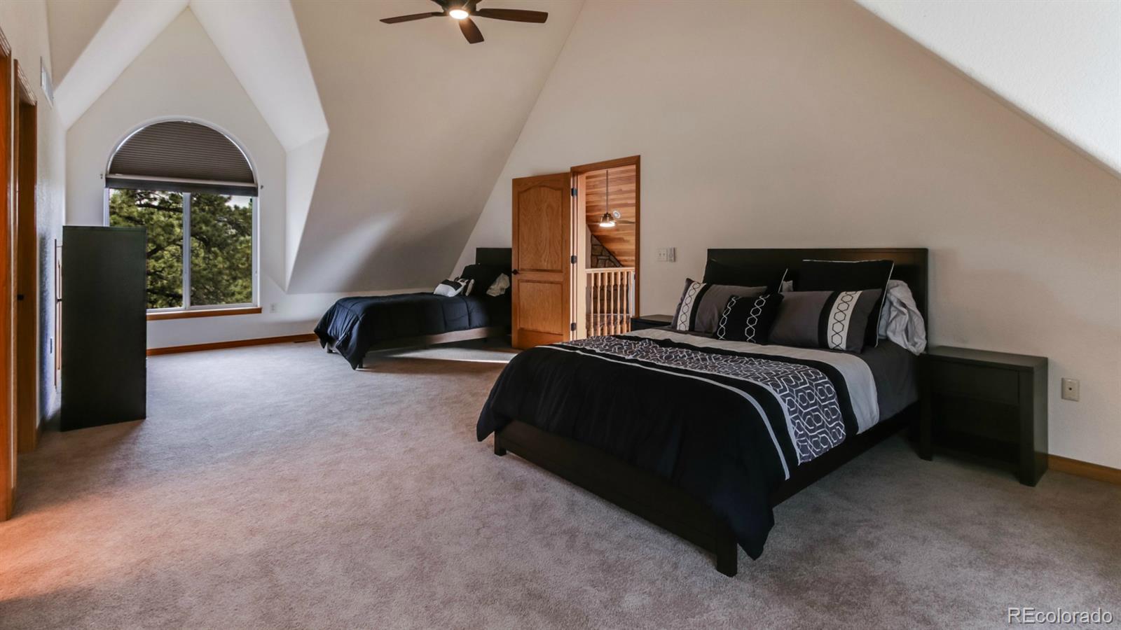 50 South Pine Road Golden, CO 80401 - Photo 23 of 35 a spacious bedroom with a bed and a window