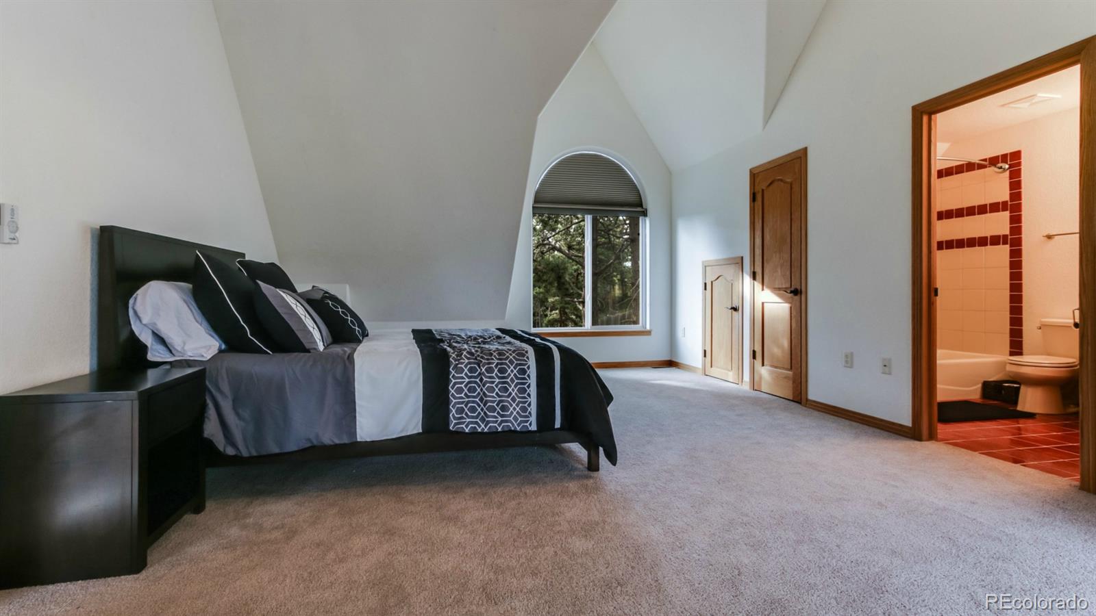 50 South Pine Road Golden, CO 80401 - Photo 29 of 35 a spacious bedroom with a bed and large windows