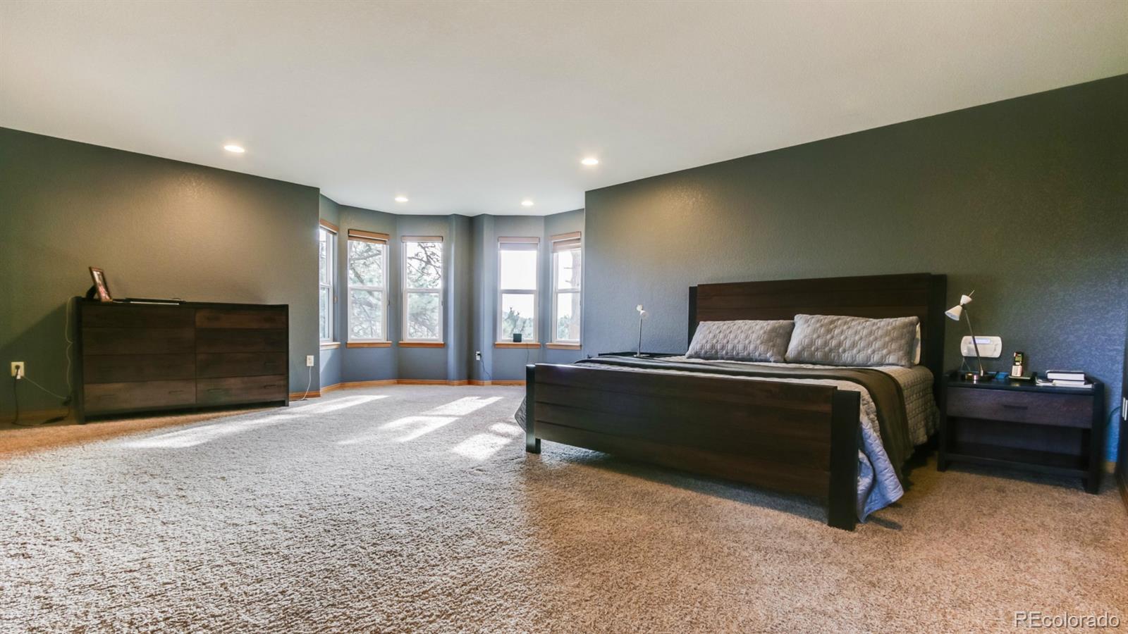 50 South Pine Road Golden, CO 80401 - Photo 6 of 35 a spacious bedroom with a bed and a fireplace