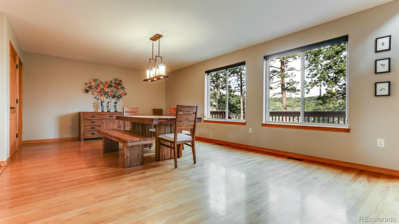 50 South Pine Road Golden, CO 80401 - Photo 7 of 35 a dining room with furniture a chandelier and wooden floor
