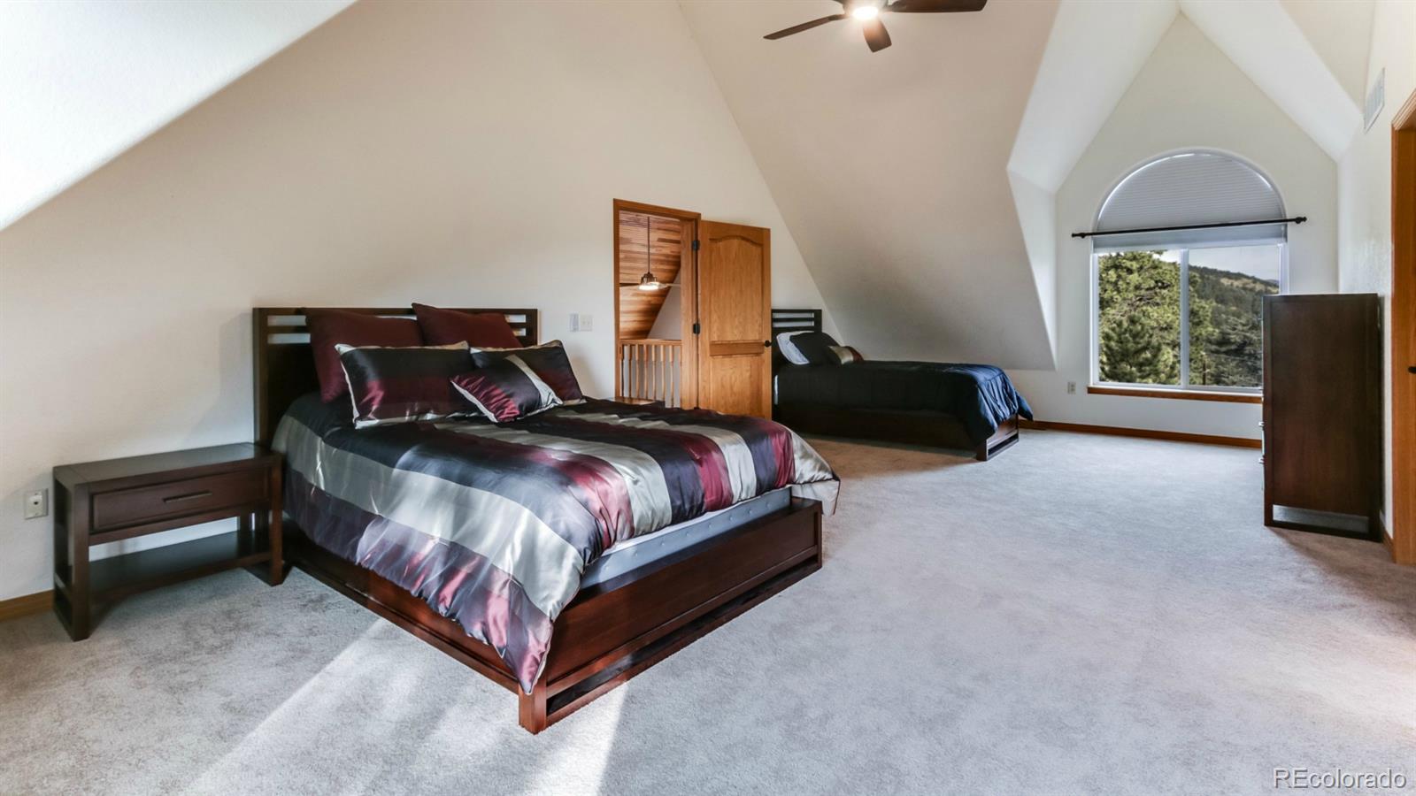 50 South Pine Road Golden, CO 80401 - Photo 8 of 35 a bed room with a bed and a chandelier