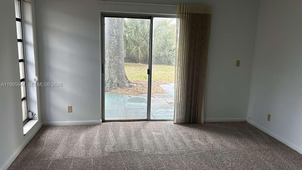 13731 Flora Place, Unit A Delray Beach, FL 33484 - Photo 1 of 21 an empty room with windows